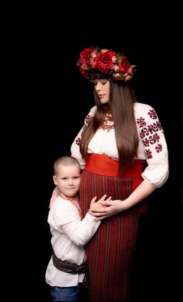 A woman holding a baby in her arms