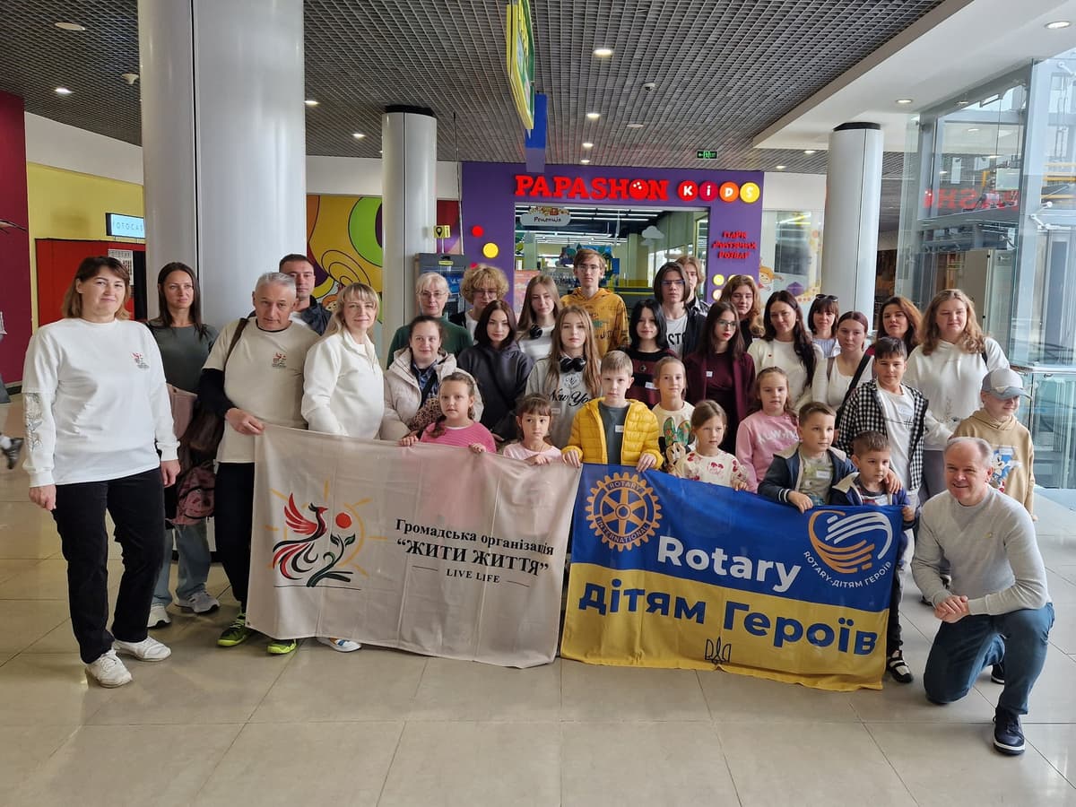 A group of people holding a banner and posing for a picture