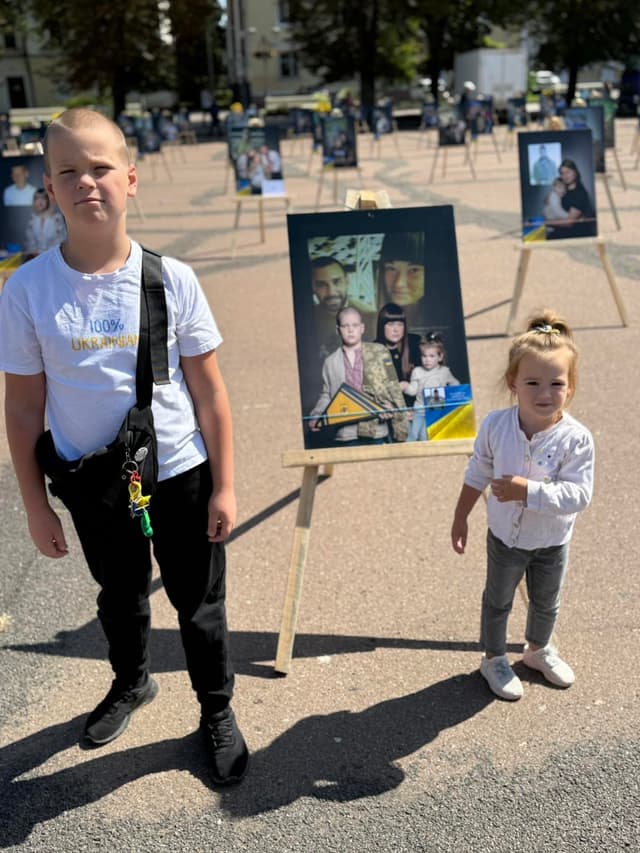 A couple of kids standing next to each other