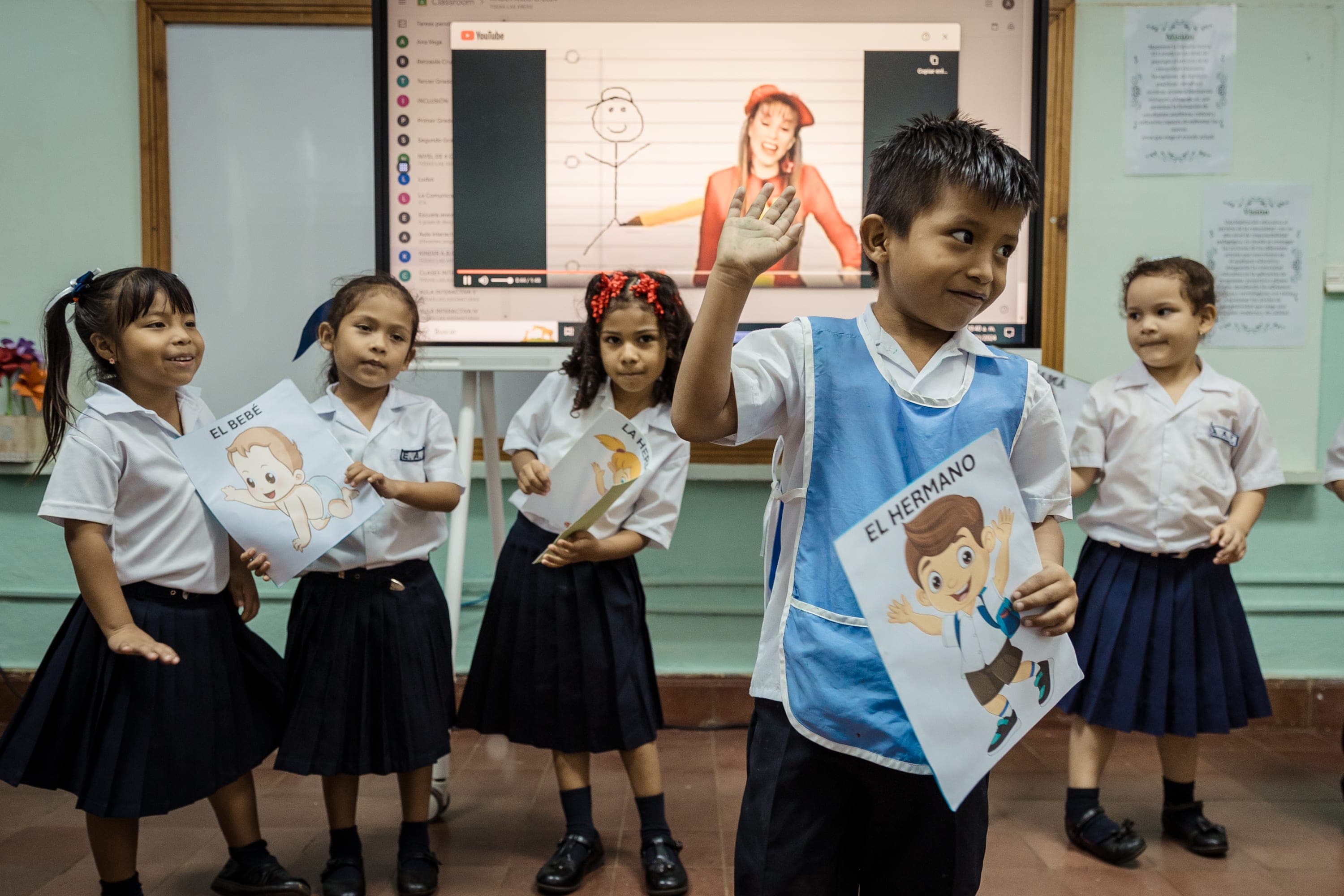 A group of young children standing next to each other