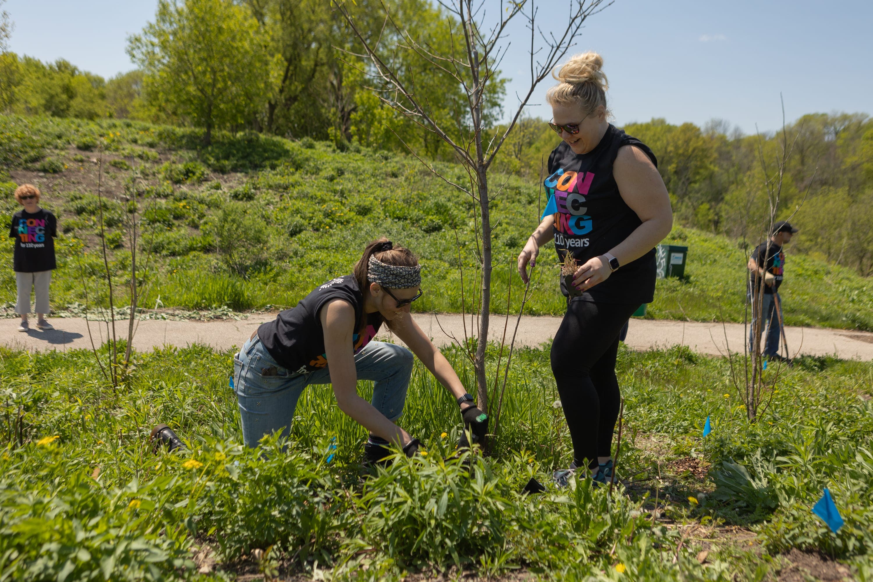 A group of people standing around a tree
