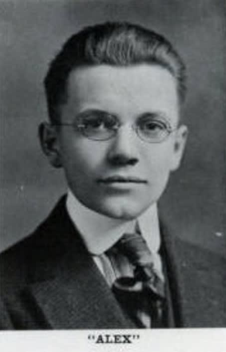 A black and white photo of a young boy wearing glasses