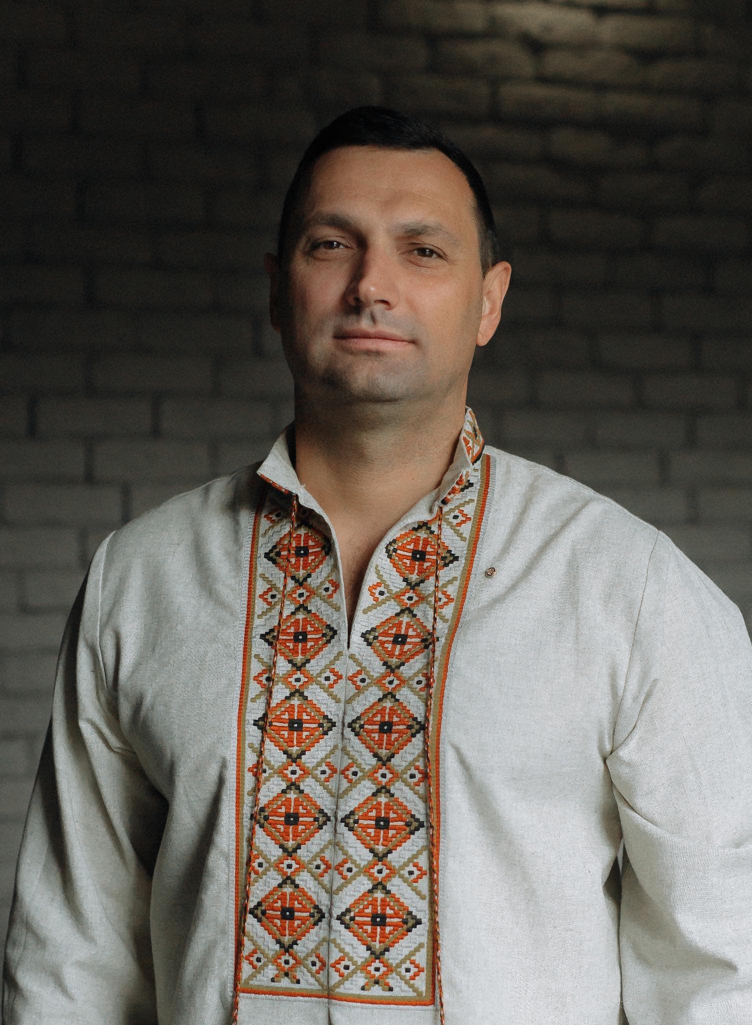 A man wearing a white shirt and a colorful tie