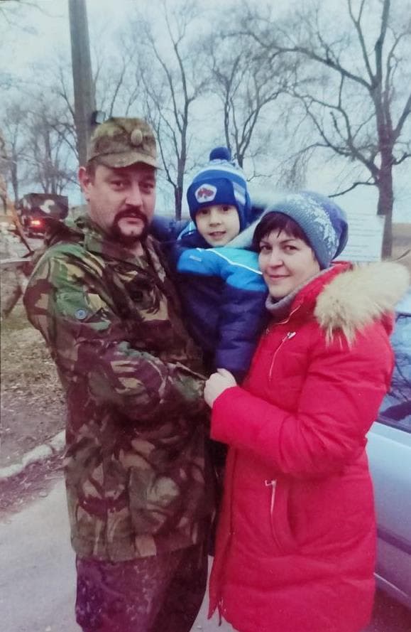 A man and a woman standing next to a car