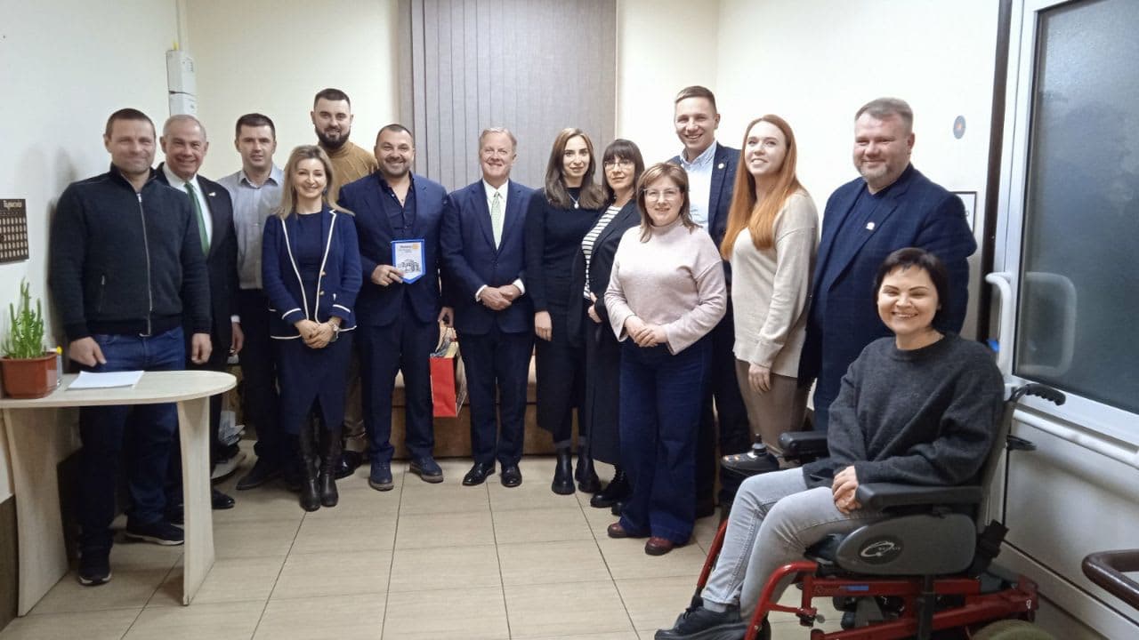A group of people standing in a room