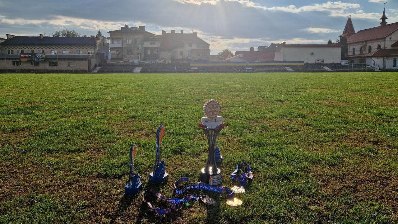 A statue of a guitar in the middle of a field