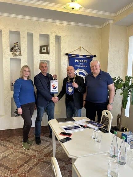 A group of people standing around a table
