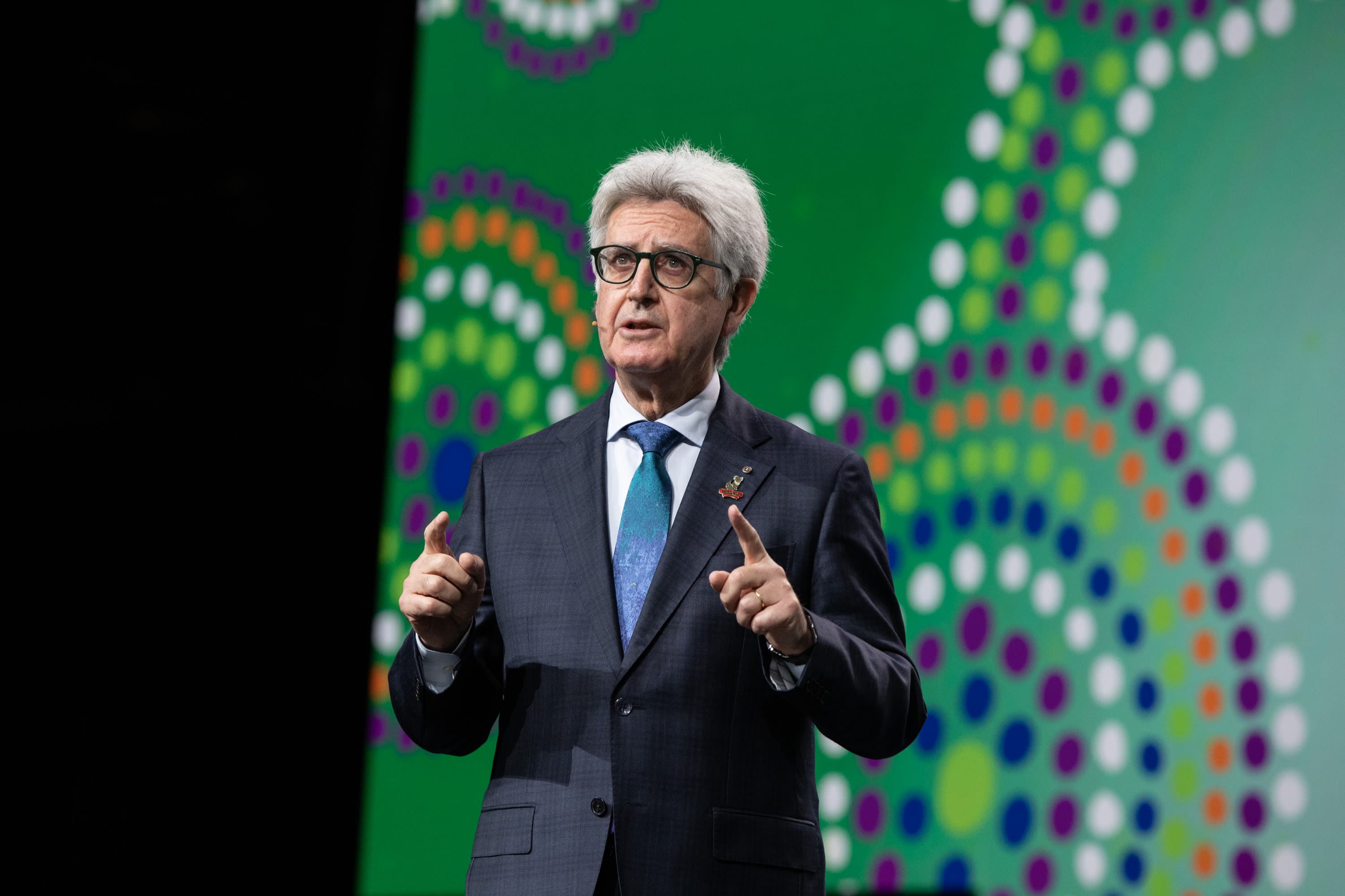 A man in a suit and tie giving a speech