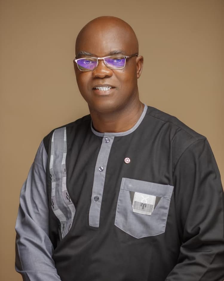 A man in a black shirt and purple glasses