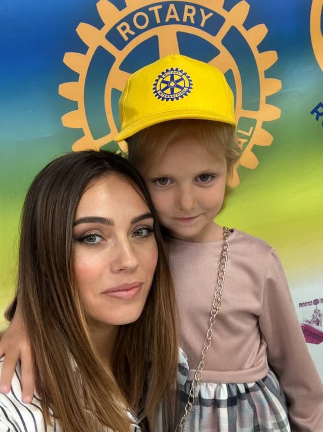 A woman and a child posing for a picture