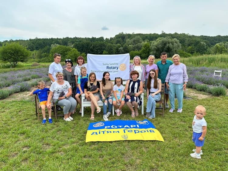 A group of people posing for a picture in a field