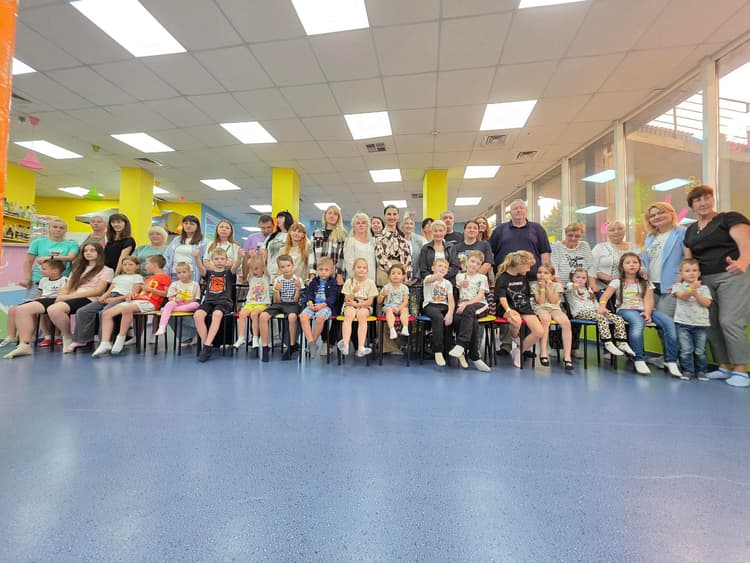 A group of people sitting in chairs in a room