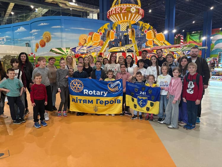 A group of people holding a banner in a building