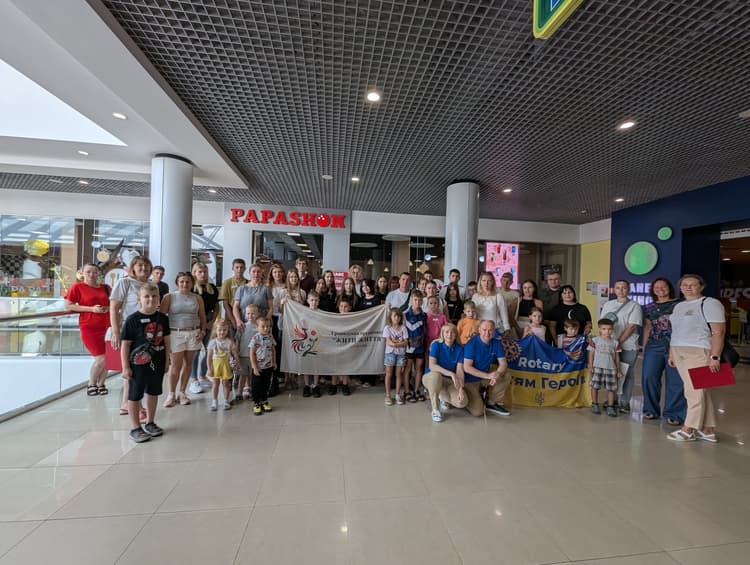 A group of people posing for a picture in a mall