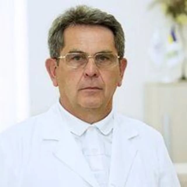 A man in a white lab coat and glasses