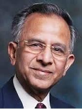 A man in a suit and tie posing for a picture