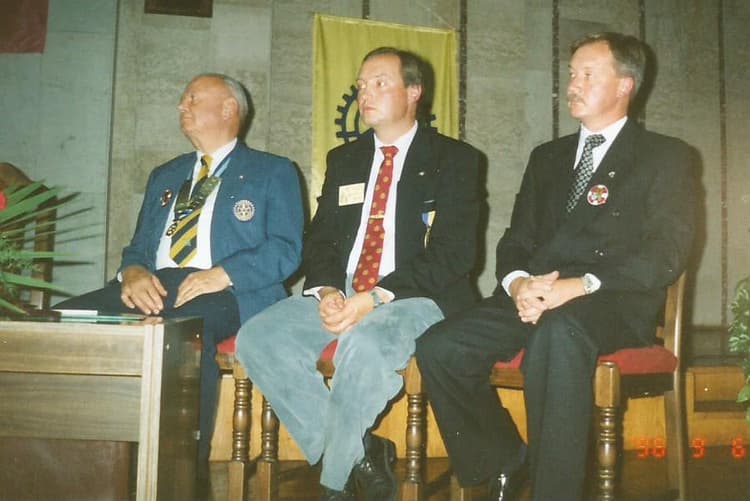 A group of men sitting next to each other