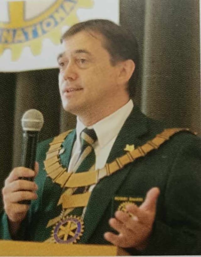 A man in a military uniform speaking into a microphone