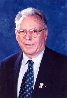 A man in a suit and tie posing for a picture
