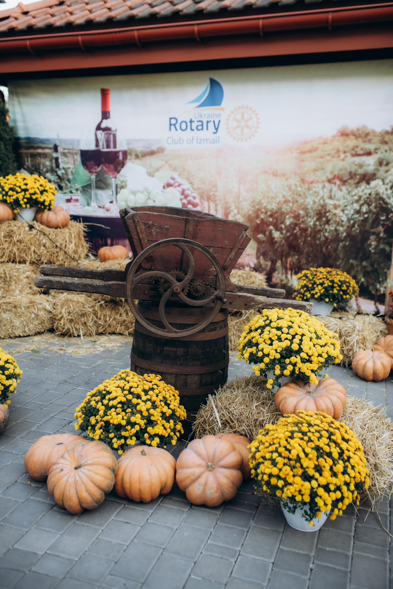 A display of pumpkins and gourds in front of a winery