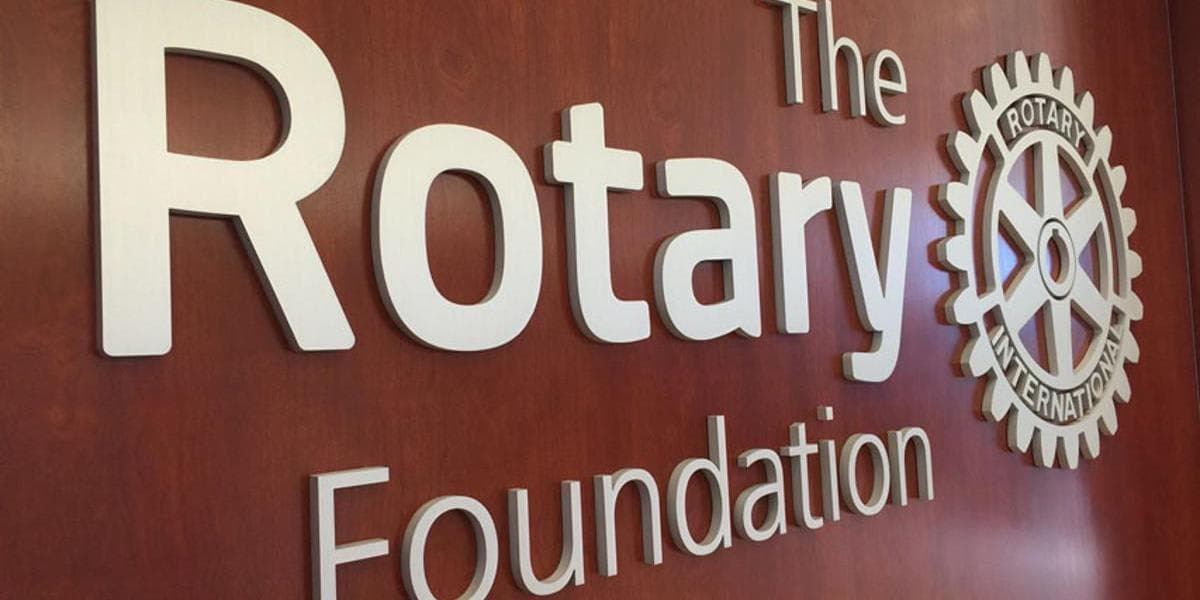 The rotary foundation logo on a wooden wall