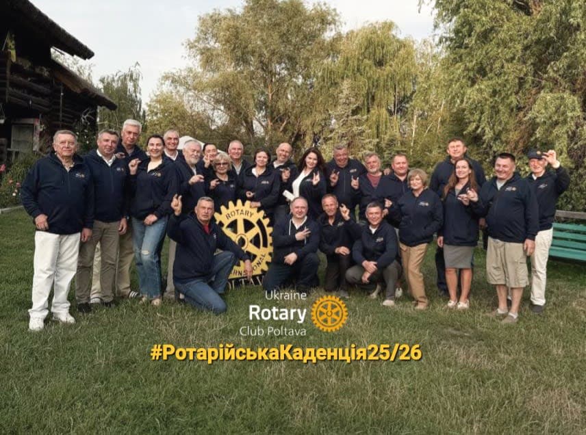 A group of people posing for a picture in front of a building