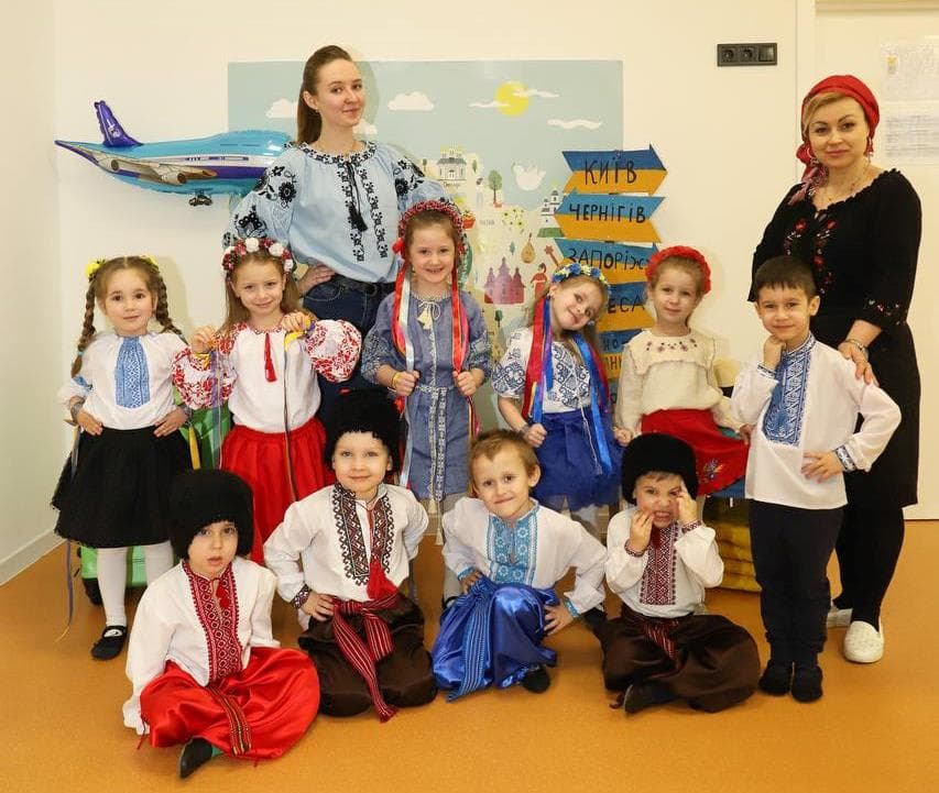 A group of children and adults posing for a picture