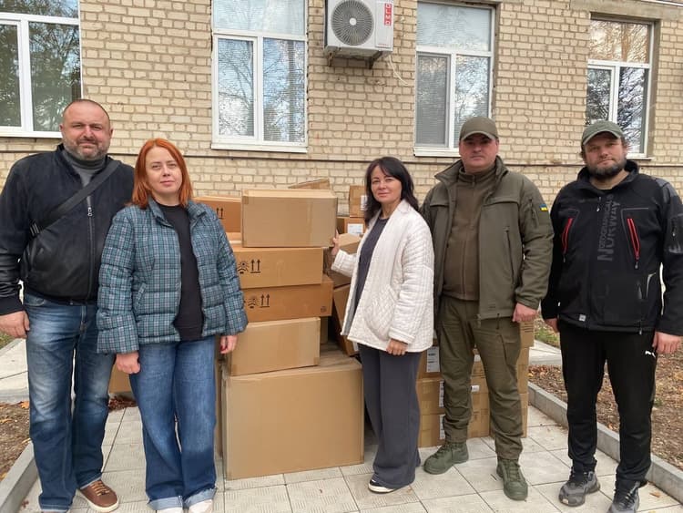 A group of people standing in front of a building