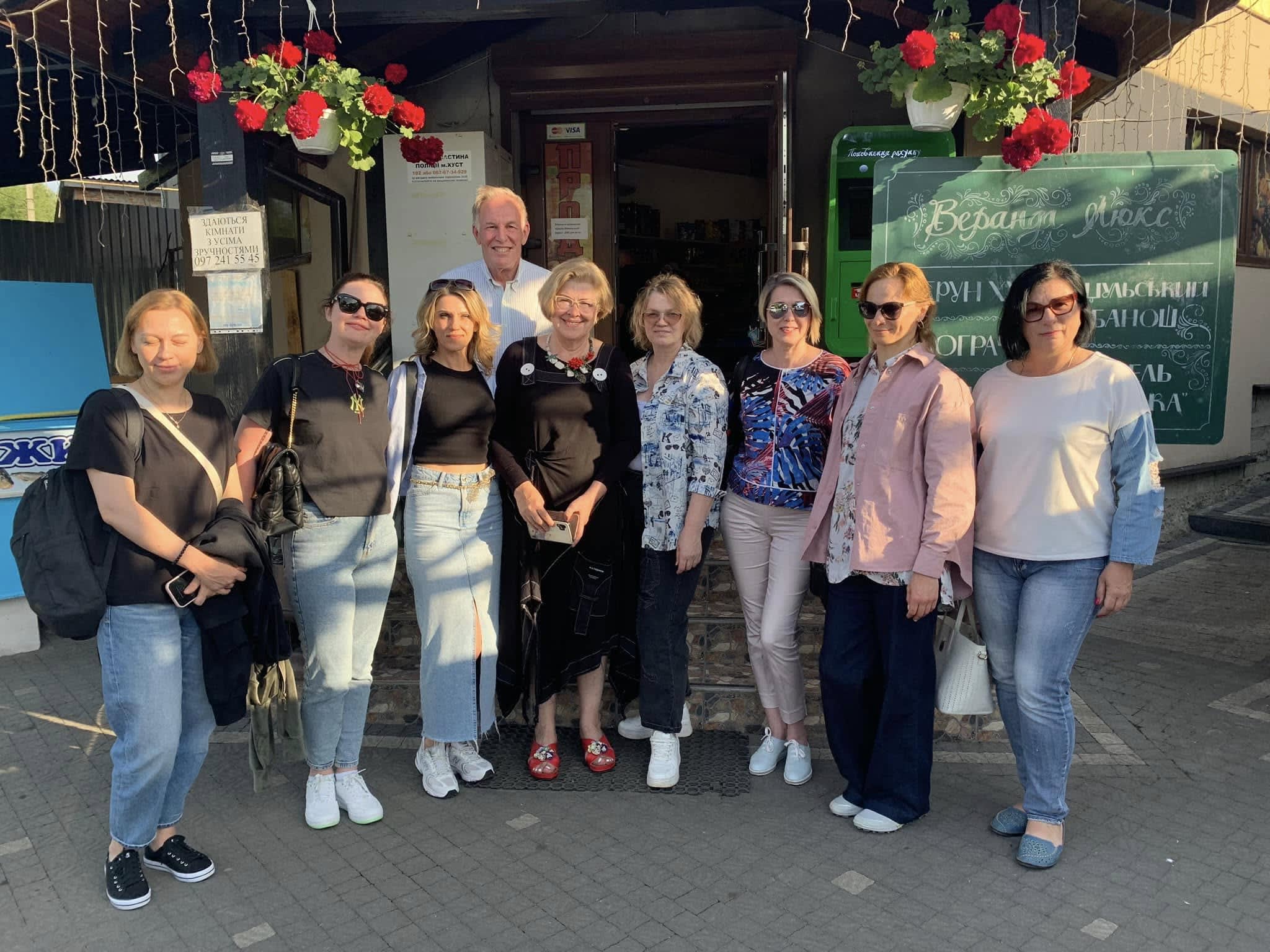 A group of people standing in front of a building