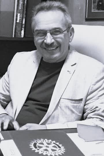 A black and white photo of a man sitting at a desk