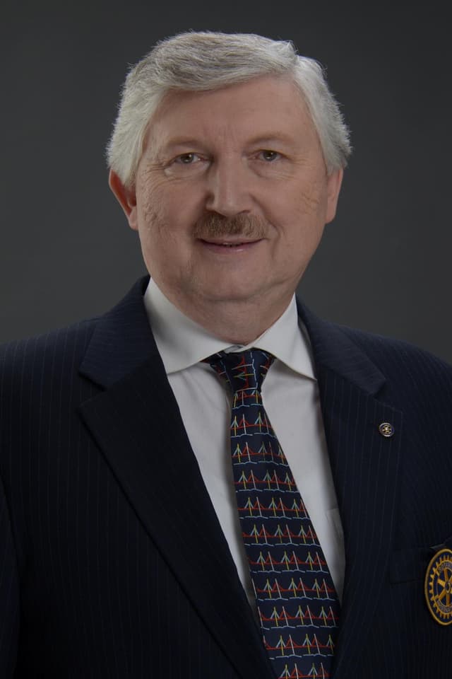 A man in a suit and tie with a mustache