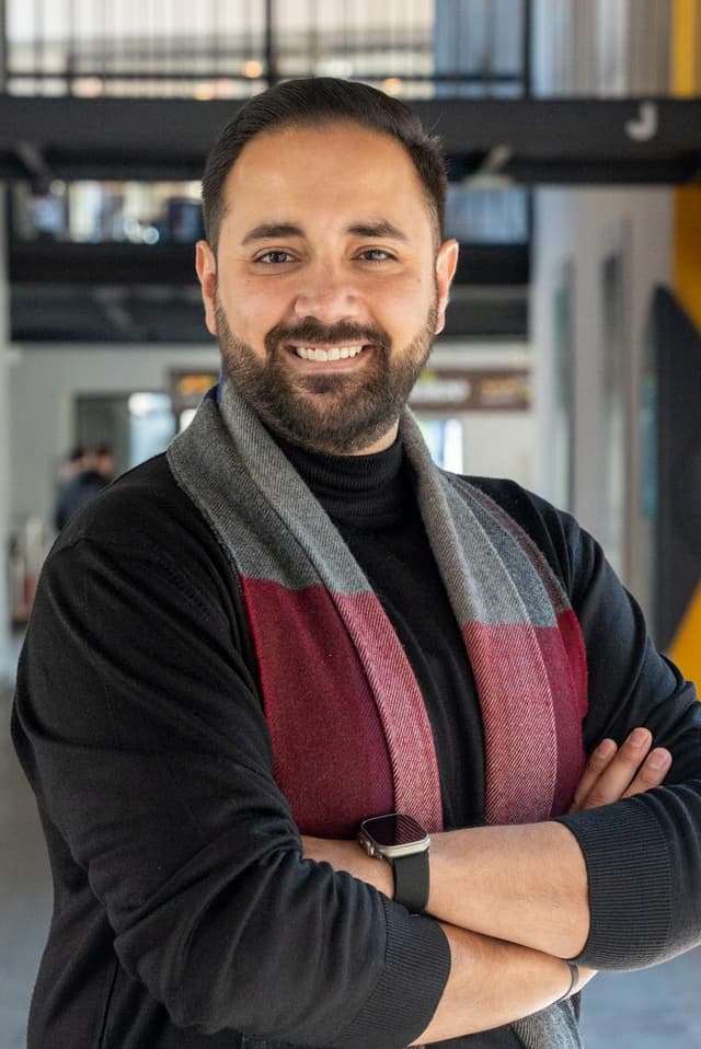 A man with a beard wearing a scarf