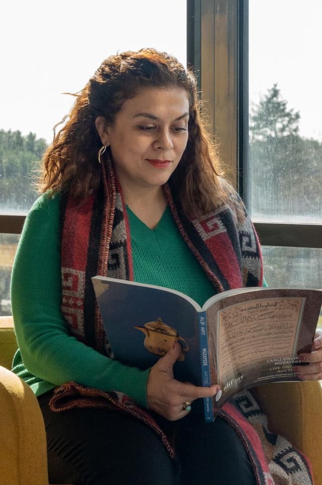 A woman sitting in a chair reading a book