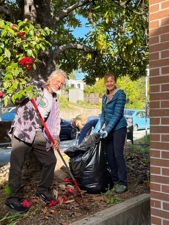 A couple of people that are standing near a tree
