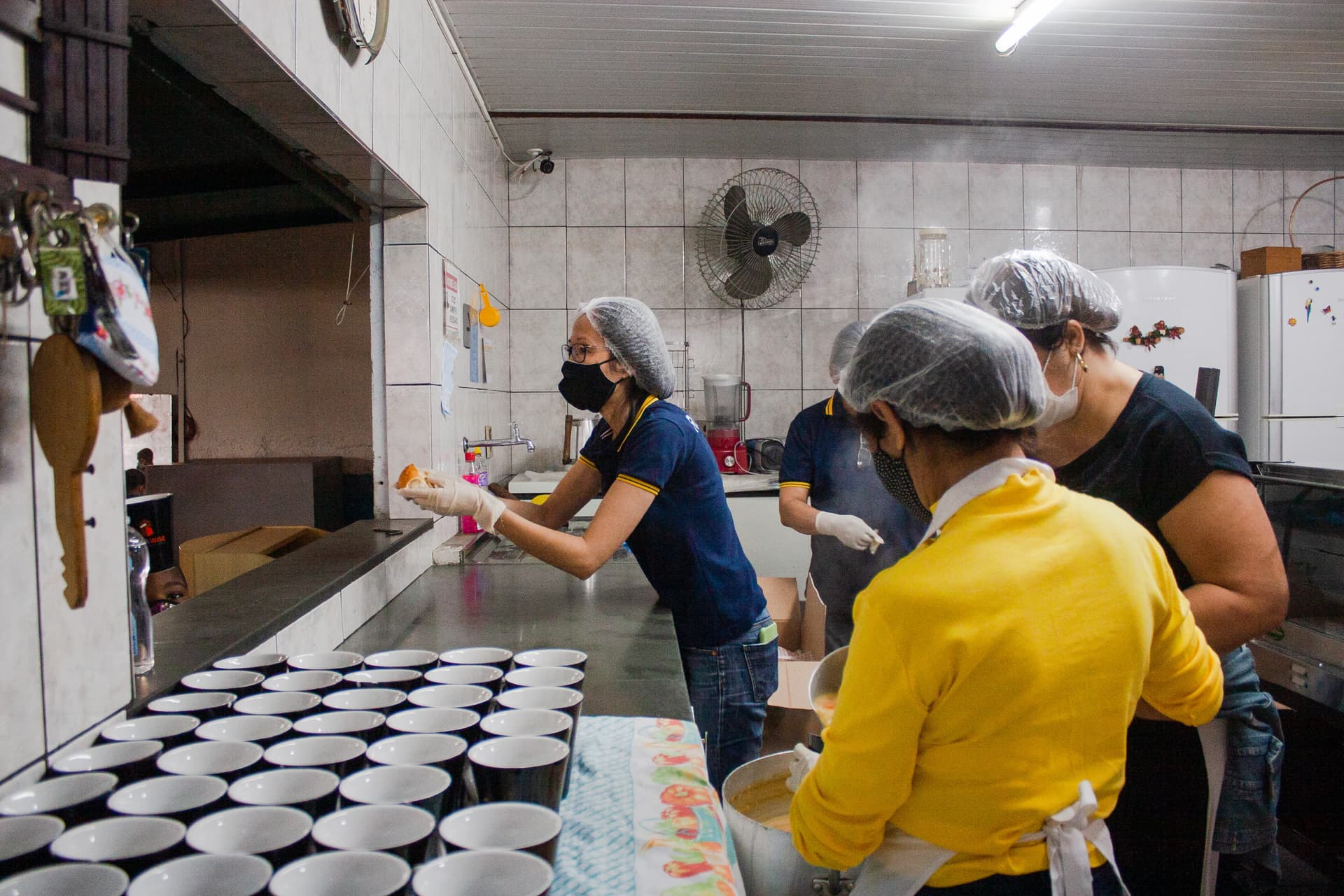 A group of people in a kitchen preparing food