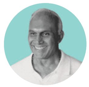 A black and white photo of a smiling man